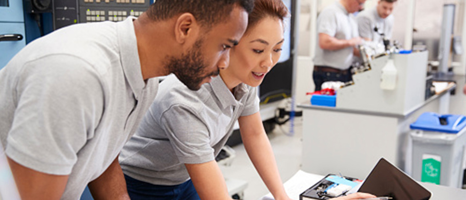 man and woman looking at a laptop